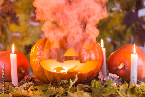 Jack-o-Lantern halloween pumpkin with mist pouring from its mouth photo