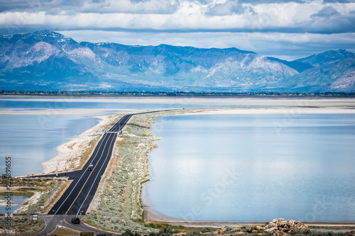 Road leading into Antelope Island State Park in Utah is on a barrier island causeway, crossing the Bridger Bay in Great Salt Lake photo