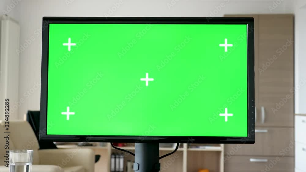 Personal computer with big green screen chroma mock-up on the table in living room of the house. Dolly slider 4K footage Personal computer with big green screen chroma mock-up on the table in living room of the house. Dolly slider 4K footage