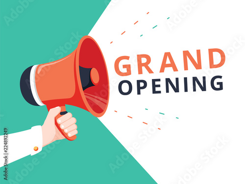 Male hand holding megaphone with Grand opening speech bubble. Loudspeaker. Banner for business, marketing
