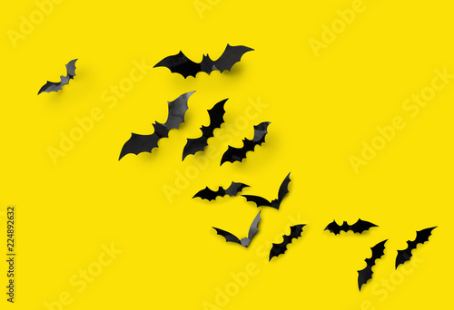 Fotótapéta halloween decorations concept - many black paper bats on yellow background