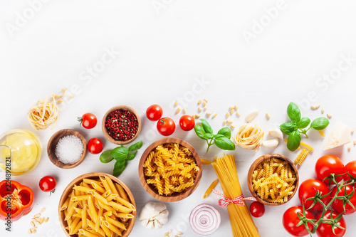 ingredients for italian cousine flat lay, pasta spaghetti penne fusilli tomato oil vegetables