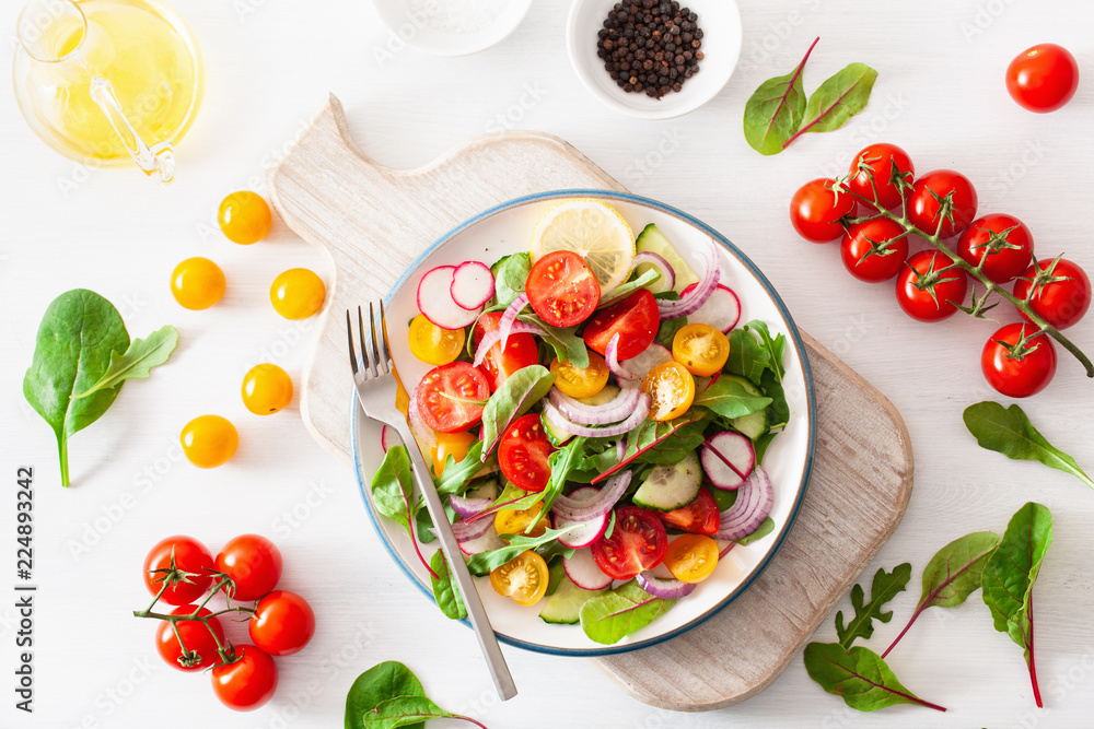 healthy colorful vegan tomato salad with cucumber, radish, onion healthy colorful vegan tomato salad with cucumber, radish, onion