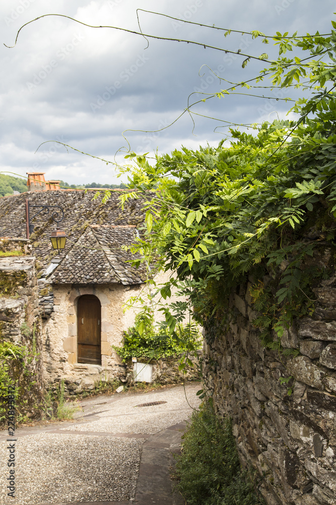 Village street with ancient walls and houses in village of Najac, Aveyron, France Village street with ancient walls and houses in village of Najac, Aveyron, France