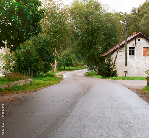 A small house on the edge of the road. A lonely house on the roadside.
