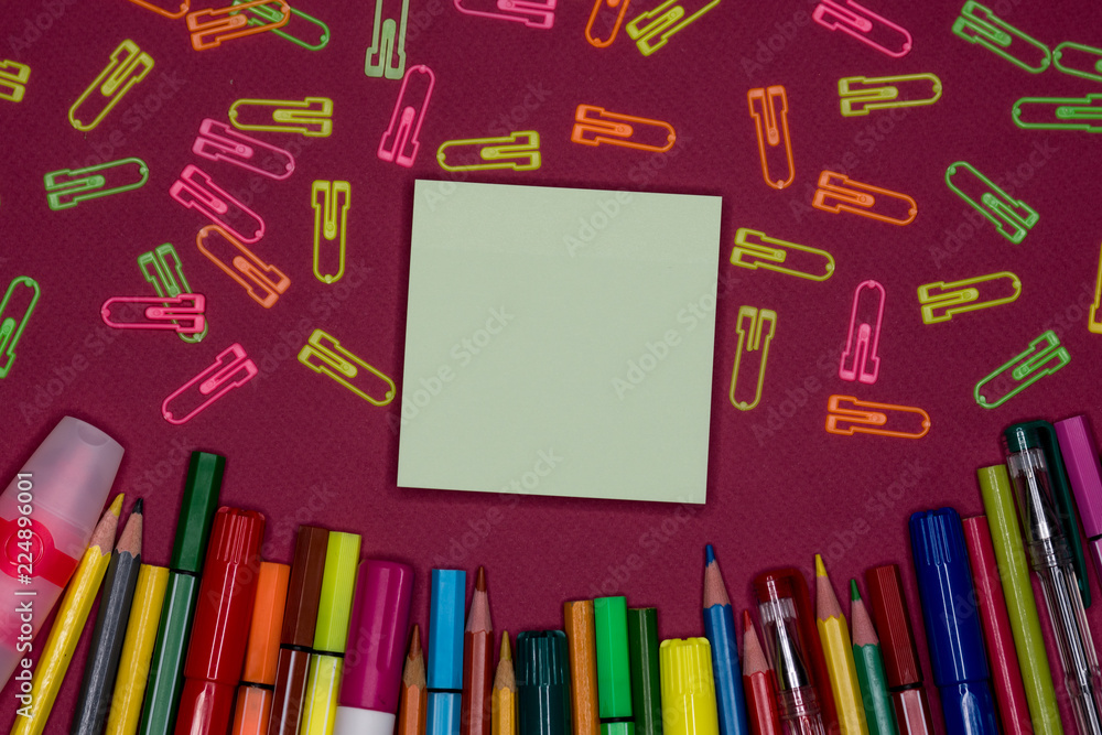Adhesive note, pencils on colorful background, blank copy space