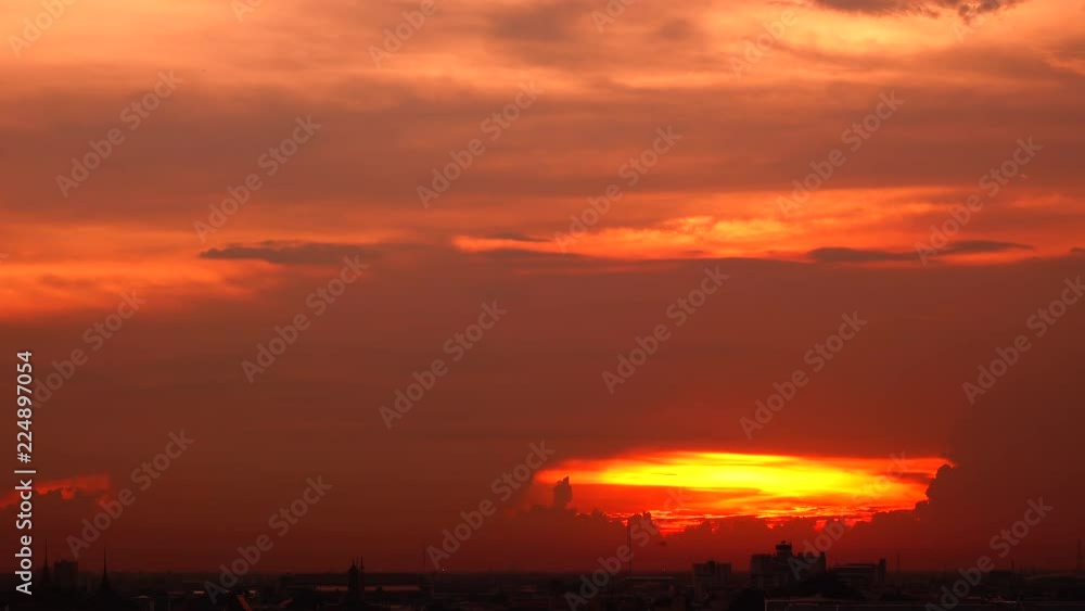 4K orange sunset as the massive sun sets into the horizon above the city 4K orange sunset as the massive sun sets into the horizon above the city