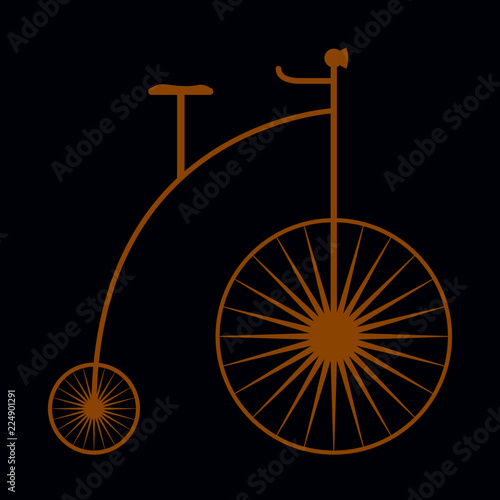 Old fashioned gold color bicycle on dark blue.