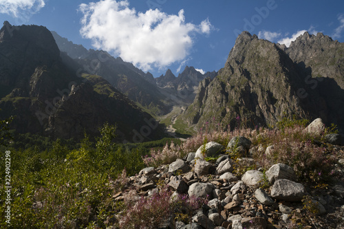 Mountain landscape, green peaks and clouds.