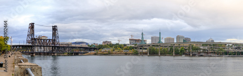 Steel bridge over Willamette river with Portland skyline © yooranpark