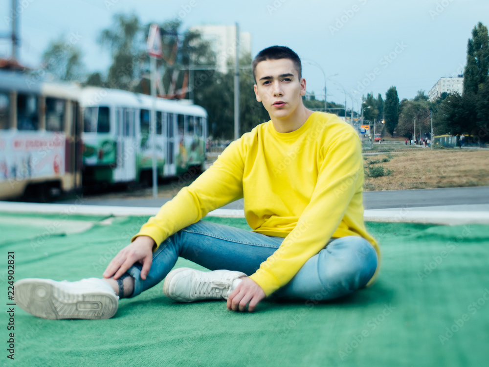 Young attractive man in a yellow sweater