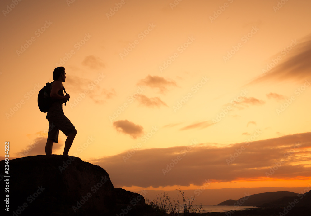 silhouette of man on top of mountain silhouette of man on top of mountain