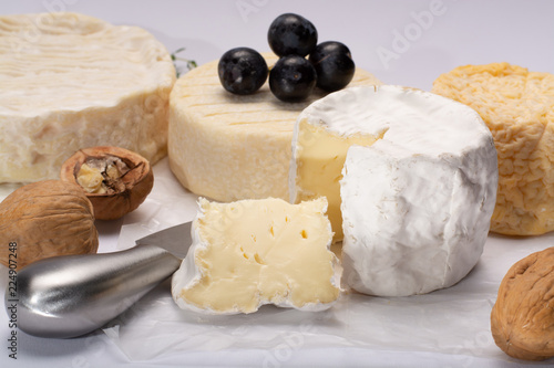 French AOC soft cow cheeses, crumbly Langres with washed rind structure, sharp Pie Angloys, camembert with strong taste and brie served as dessert after dinner