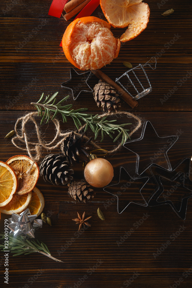 Christmas atmoshpere flatlay. Overhead view. Gingerbread cookies, tangerines and new year decorations on wooden background Christmas atmoshpere flatlay. Overhead view. Gingerbread cookies, tangerines and new year decorations on wooden background