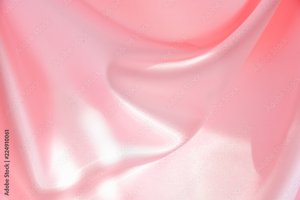 The texture of the satin fabric of pink color for the background The texture of the satin fabric of pink color for the background
