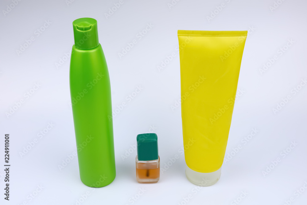 bottles with liquid and cosmetics on white background bottles with liquid and cosmetics on white background