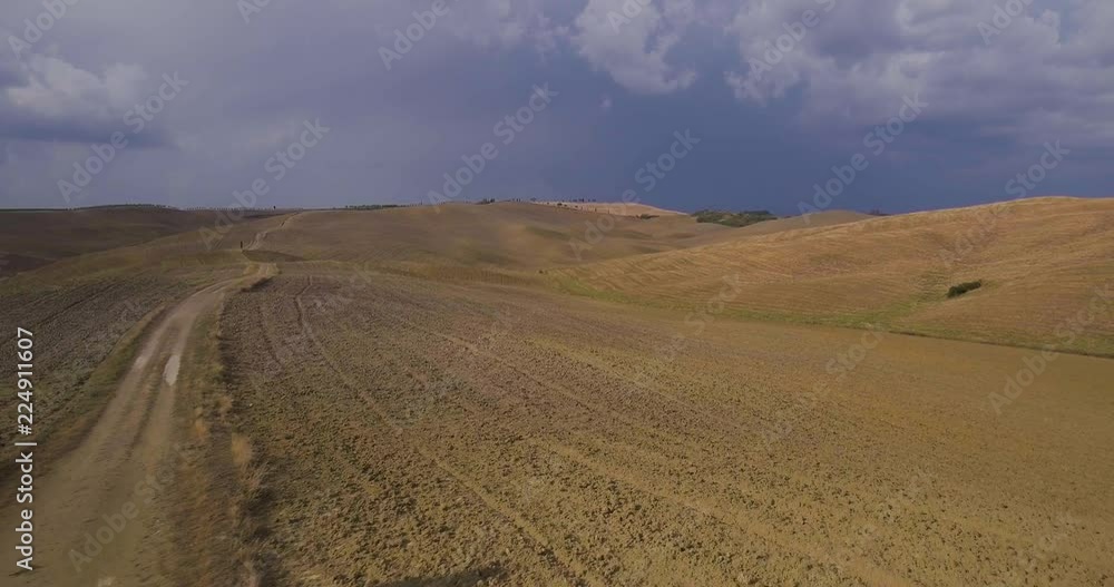 Aerial, beautiful view on tuscan fall landscape with a lonely cypress tree in the middle of fields in Tuscany Aerial, beautiful view on tuscan fall landscape with a lonely cypress tree in the middle of fields in Tuscany