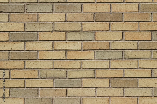 Vintage yellow brick wall background in varying shades yellow, beige, pink and tan