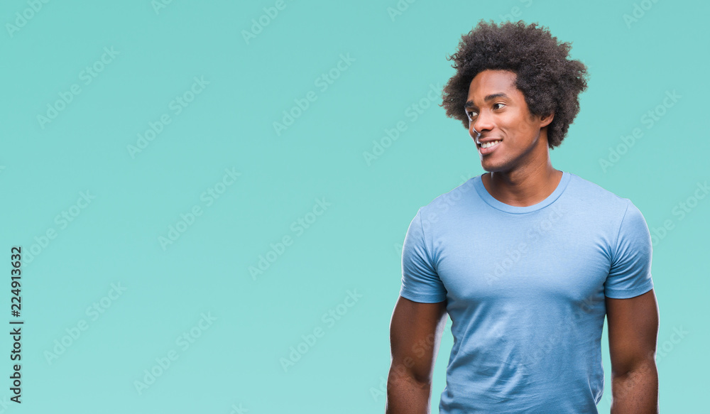 Afro american man over isolated background looking away to side with smile on face, natural expression. Laughing confident. Afro american man over isolated background looking away to side with smile on face, natural expression. Laughing confident.