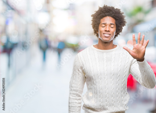 Afro american man over isolated background showing and pointing up with fingers number five while smiling confident and happy. © Krakenimages.com