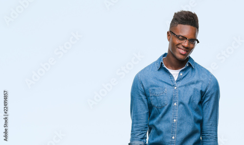 Young african american man over isolated background winking looking at the camera with sexy expression, cheerful and happy face. © Krakenimages.com