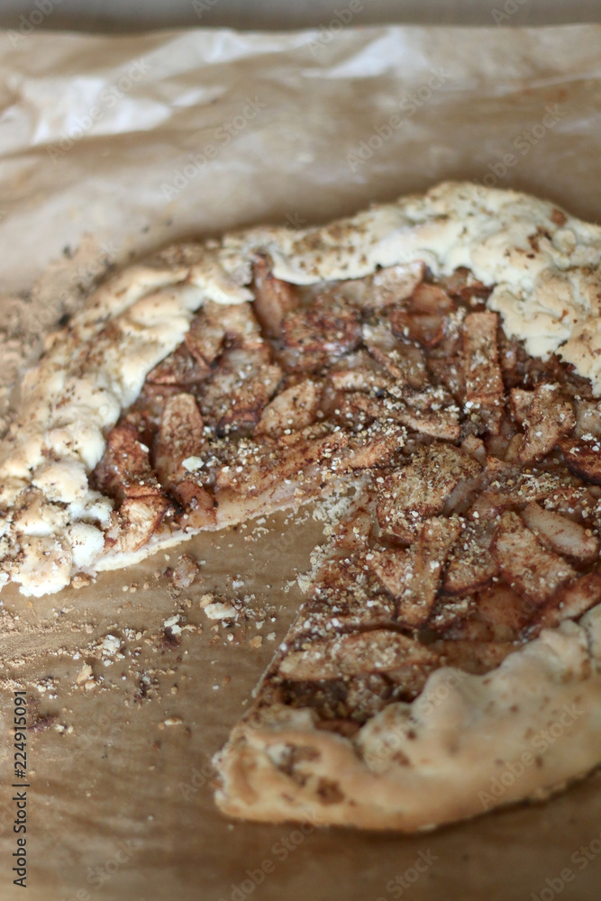 Apple galette with cinnamon and minced walnuts. Homemade sugar free dessert. Selective focus.