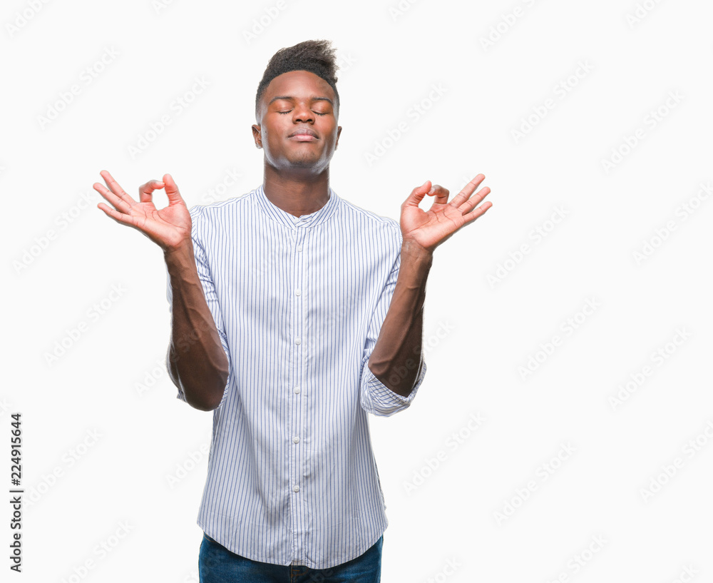 Fototapeta premium Young african american man over isolated background relax and smiling with eyes closed doing meditation gesture with fingers. Yoga concept.