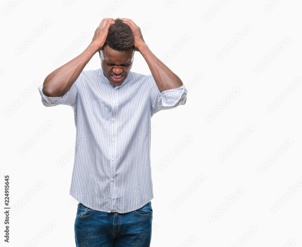 Young african american man over isolated background suffering from headache desperate and stressed because pain and migraine. Hands on head. Young african american man over isolated background suffering from headache desperate and stressed because pain and migraine. Hands on head.