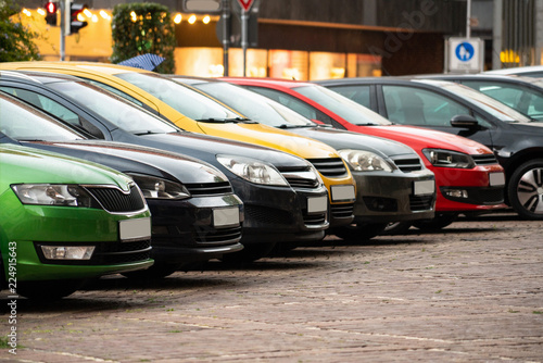 Multicolored cars parked on a city street © scharfsinn86