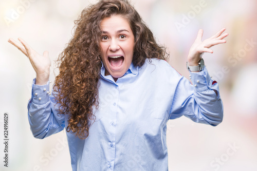 Beautiful brunette curly hair young girl wearing elgant look over isolated background celebrating crazy and amazed for success with arms raised and open eyes screaming excited. Winner concept photo