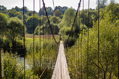 Suspension bridge over the Protva river in the village of Satino, Borovsky district, Kaluzhskiy region, Russia photo