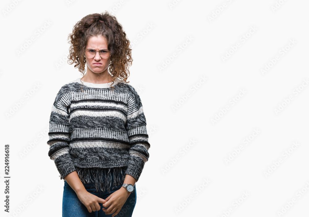 Beautiful brunette curly hair young girl wearing glasses over isolated background skeptic and nervous, frowning upset because of problem. Negative person. Beautiful brunette curly hair young girl wearing glasses over isolated background skeptic and nervous, frowning upset because of problem. Negative person.