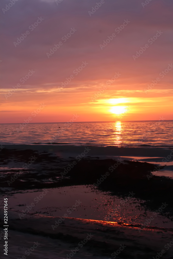 Sunset reflected on the beach in Jurmala