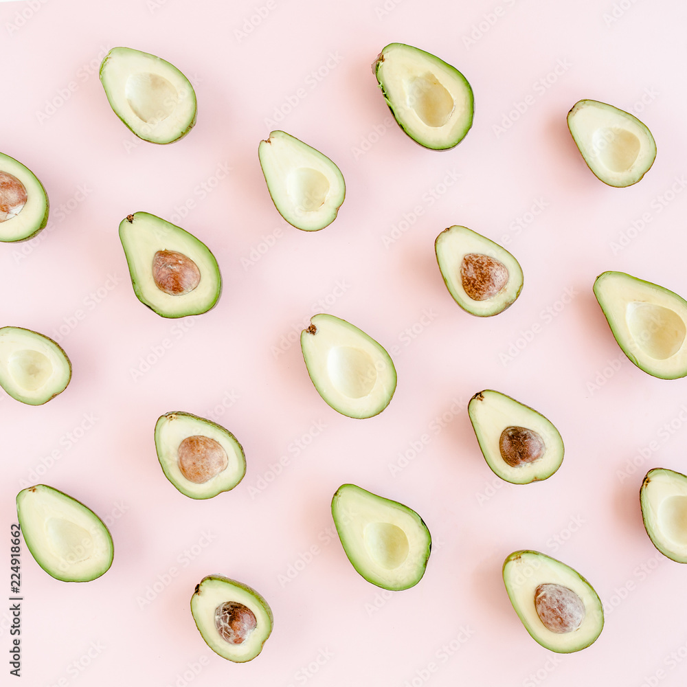 Avocado on pink background. Tropical abstract background with avocado. Food concept. flat lay, top view