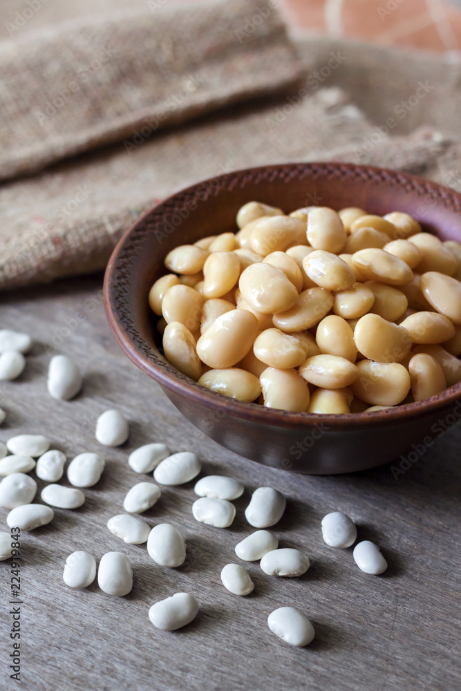 Boiled white kidney beans in a rustic bowl Boiled white kidney beans in a rustic bowl