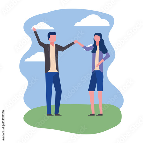 young couple holding hands celebrating in landscape