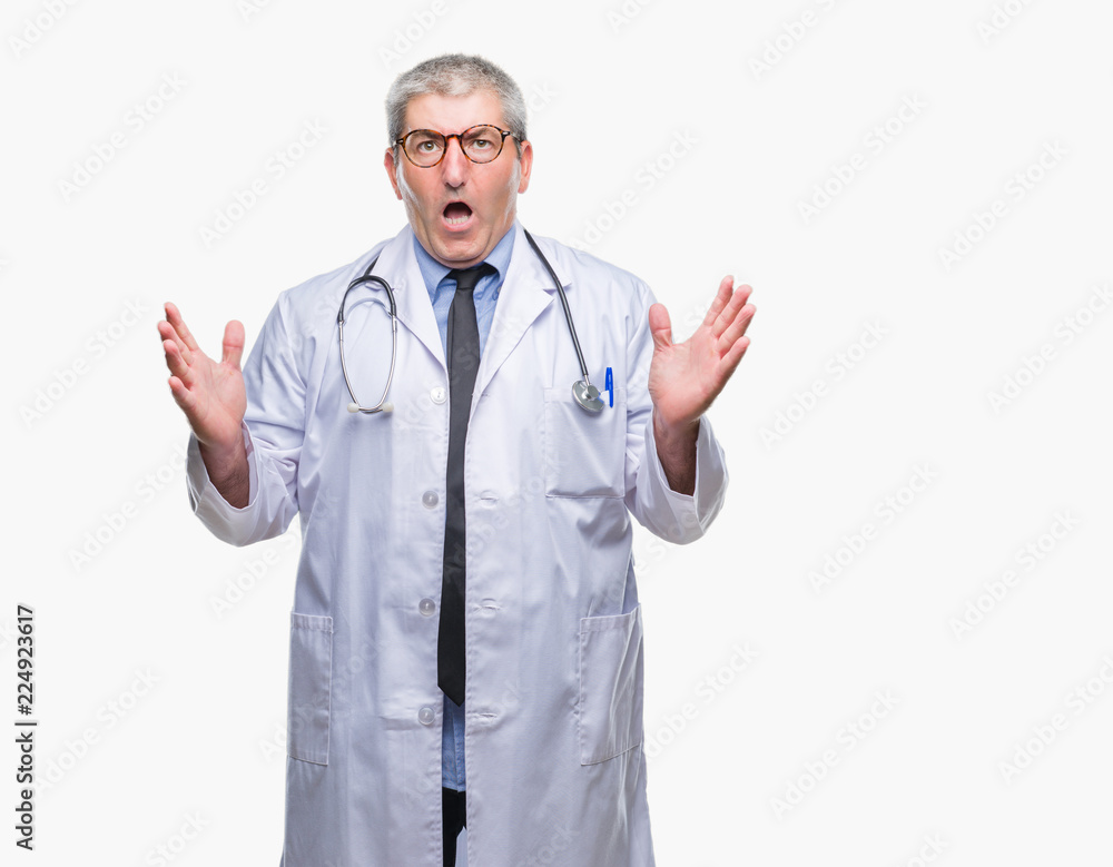 Handsome senior doctor man over isolated background crazy and mad shouting and yelling with aggressive expression and arms raised. Frustration concept. Handsome senior doctor man over isolated background crazy and mad shouting and yelling with aggressive expression and arms raised. Frustration concept.