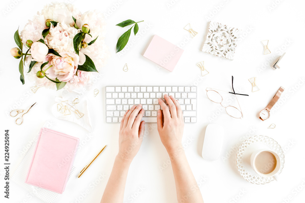 Flat lay women's office desk. Female workspace with female hands, computer, pink peonies bouquet, accessories on white background. Top view feminine background. Flat lay women's office desk. Female workspace with female hands, computer, pink peonies bouquet, accessories on white background. Top view feminine background.
