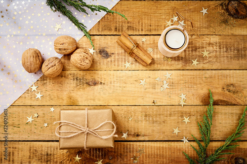 beautiful Christmas Eve background on an old wooden table with gifts and nuts decorations photo