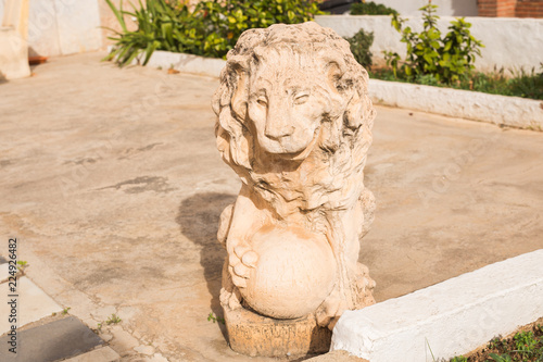 Stone lion statue. Marble Sculpture of a lion on pedestal photo
