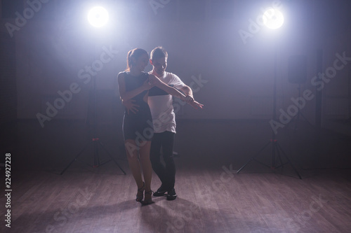 Young couple dancing latin dance Bachata  merengue  salsa. Two elegance pose in dance class
