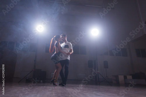 Young couple dancing latin dance Bachata, merengue, salsa. Two elegance pose in dance class © satura_