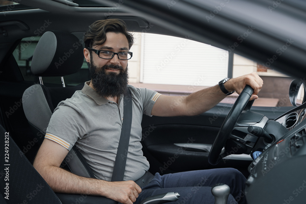 Obraz premium Happy car driver with fastened seat belt