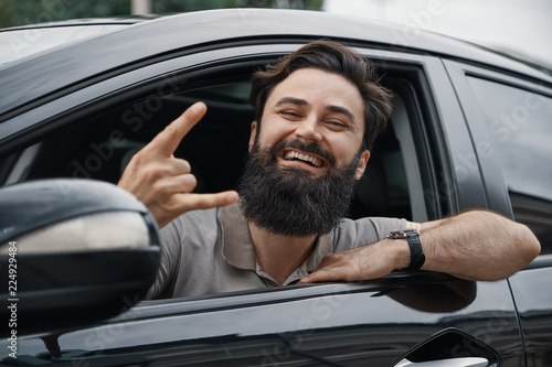 Close up side portrait of happy man driving car © arthurhidden