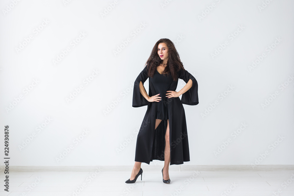 Smiling brunette woman in halloween makeup posing over light background with copy space Smiling brunette woman in halloween makeup posing over light background with copy space