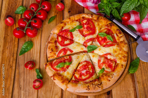 traditional Italian pizza margarita with tomatoes and mozzarella cheese