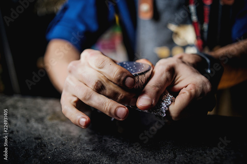 a man is hammering a hookah photo