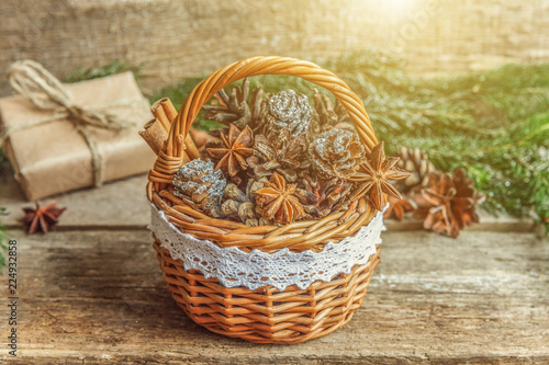 Christmas New Year composition with gift box fir branch basket pine cones on old shabby rustic wooden background. Xmas holiday december decoration to Russian tradition. Flat lay  copy space