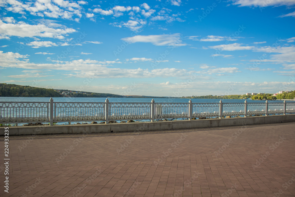 embankment outdoor park waterfront lake shore line district in Ukrainian city Ternopil in bright colorful day time with blue sky 
