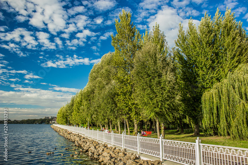 embankment outdoor park waterfront lake shore line district in Ukrainian city Ternopil in bright colorful day time with blue sky 